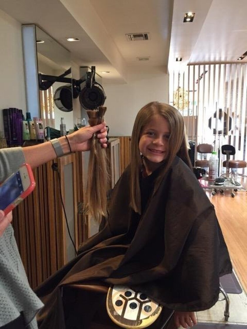 Six-year-old Ryder Perryman with her donated hair