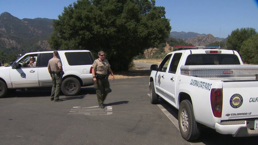 Investigators at Malibu Creek State Park, where a father was fatally shot in his tent while he was camping with his young daughters.