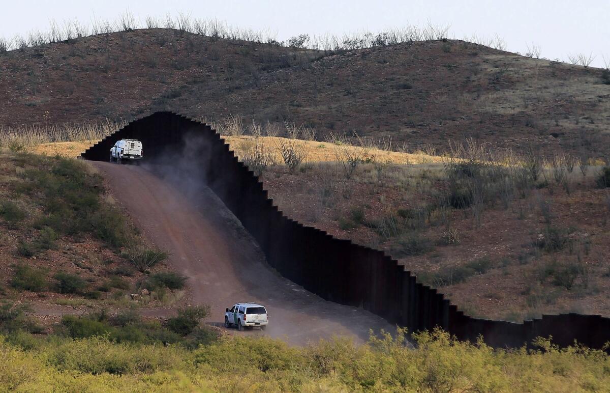 Border Patrol agents patrol the U.S.-Mexico border fence near Naco, Ariz., in 2012. Unaccompanied youths who cross into the country illegally often are housed at shelters until placed with a relative or sponsor.