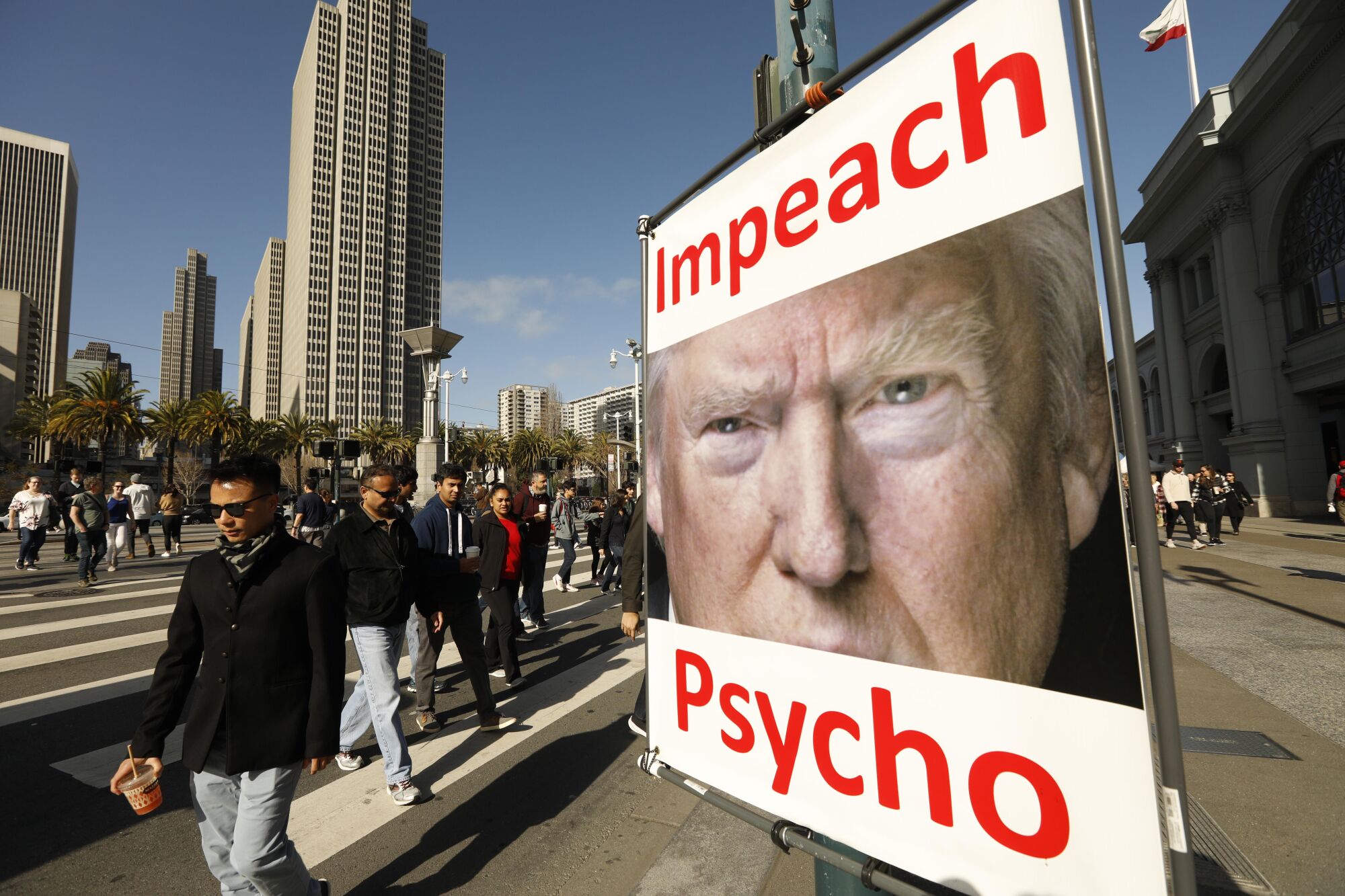 An anti-Trump poster is mounted on a lamppost along San Francisco's Embarcadero