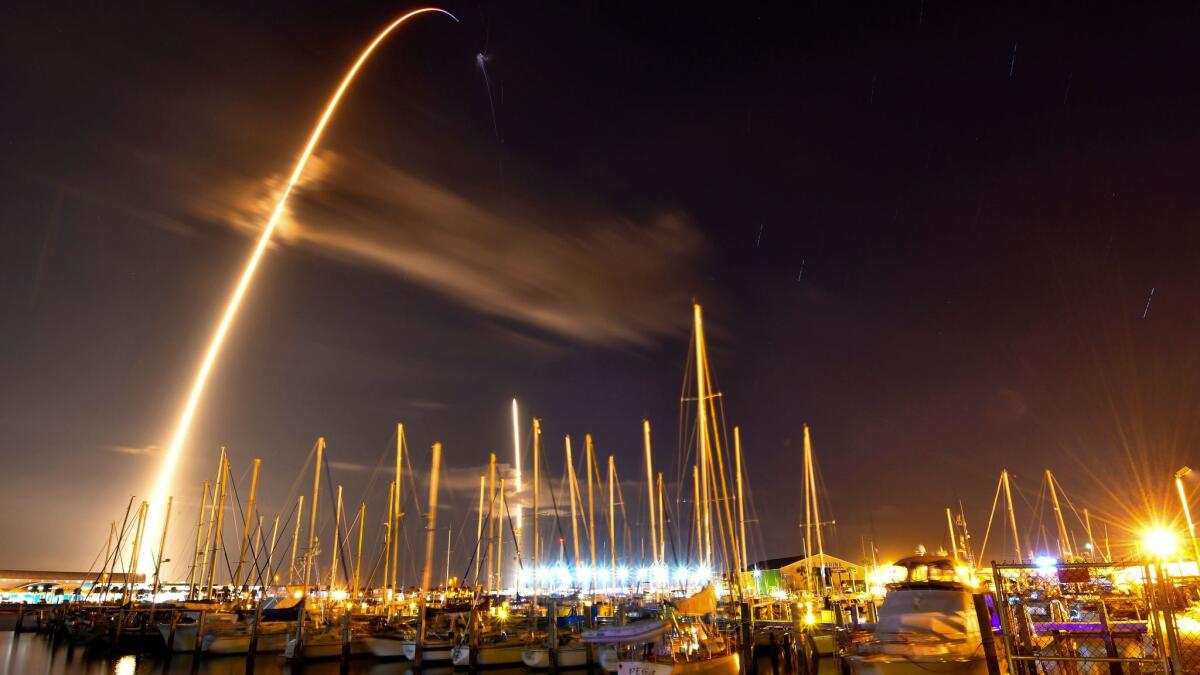 In this image made with an 8-minute long exposure, a SpaceX Falcon 9 rocket launches from Cape Canaveral Air Force Station, as seen from from the Ocean Club Marina in Port Canaveral, Fla.