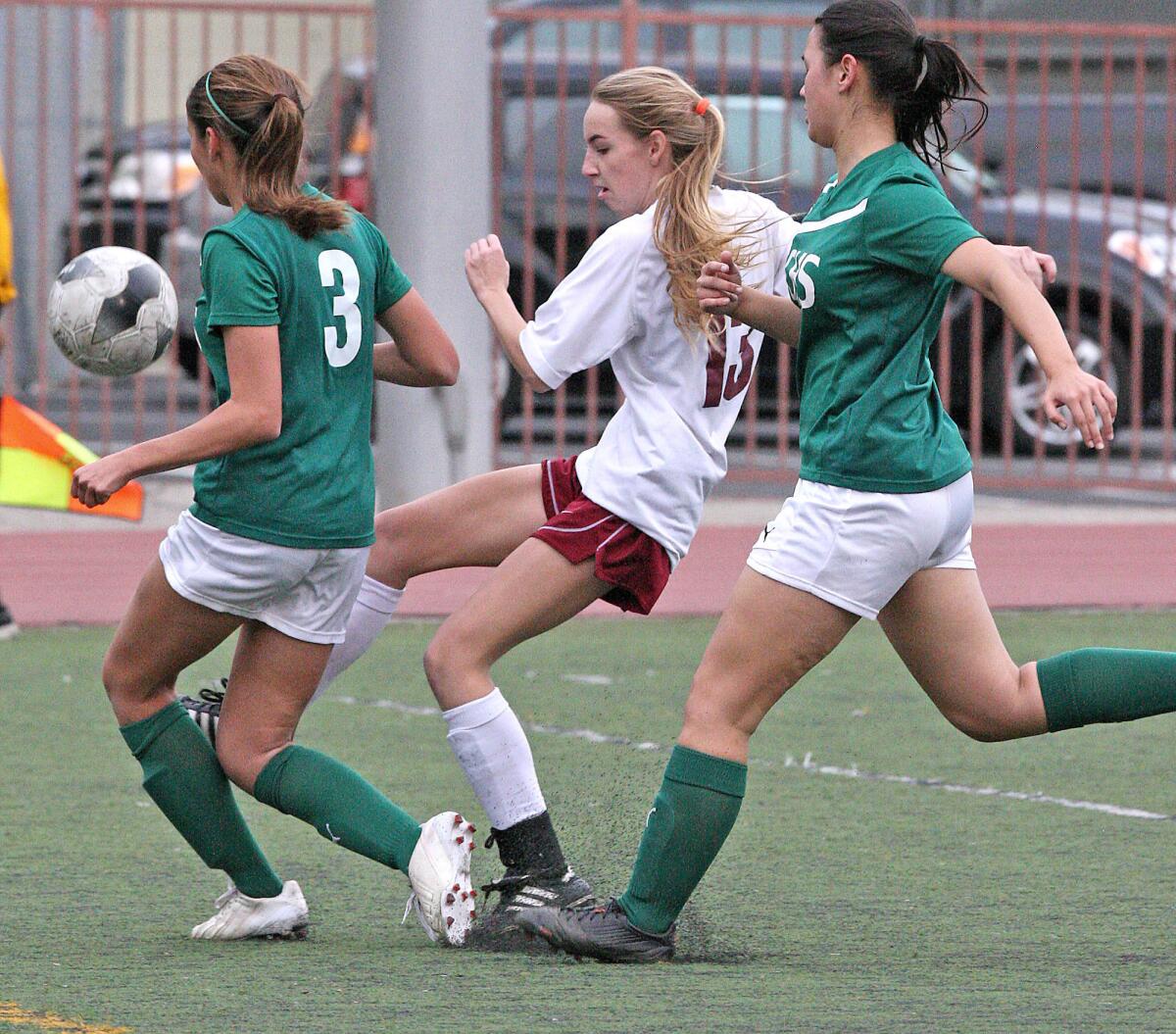 La Canada's Katherine Sheehy makes a goal attempt with Temple City's Alexxis Molinar and Sara Kubo defending during a match at La Cañada High on Friday, January 24, 2014.