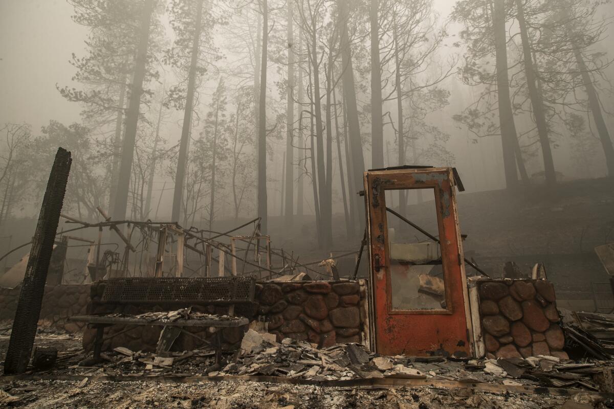  A door stands upright among the rubble from the Dixie fire. 