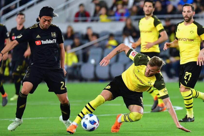 Andrey Yarmolenko (R) of Borussia Dortmund vies for the ball with Lee Nguyen (L) of LAFC (Los Angeles Football Club) during their international soccer friendly in Los Angeles, California on May 22, 2018. The game ended in a 1-1 draw. / AFP PHOTO / Frederic J. BROWNFREDERIC J. BROWN/AFP/Getty Images ** OUTS - ELSENT, FPG, CM - OUTS * NM, PH, VA if sourced by CT, LA or MoD **