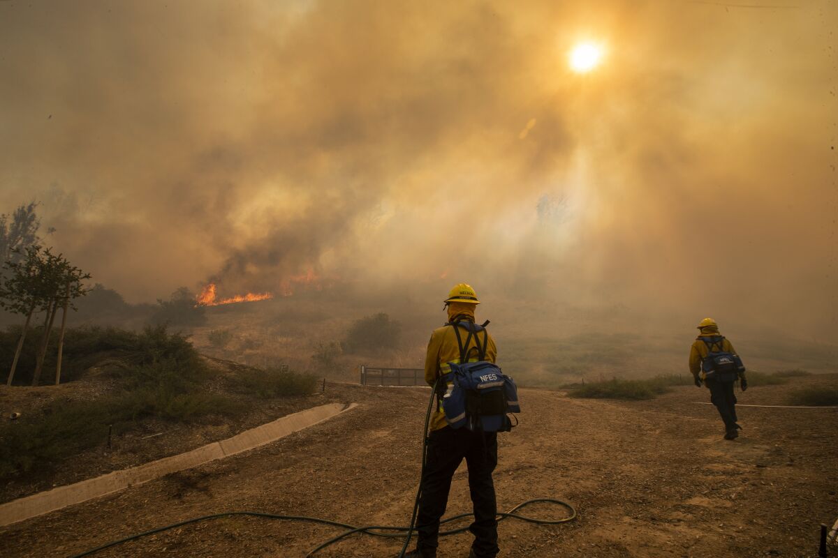 Orange County firefighters amid the smoke of the Silverado fire in Irvine.  