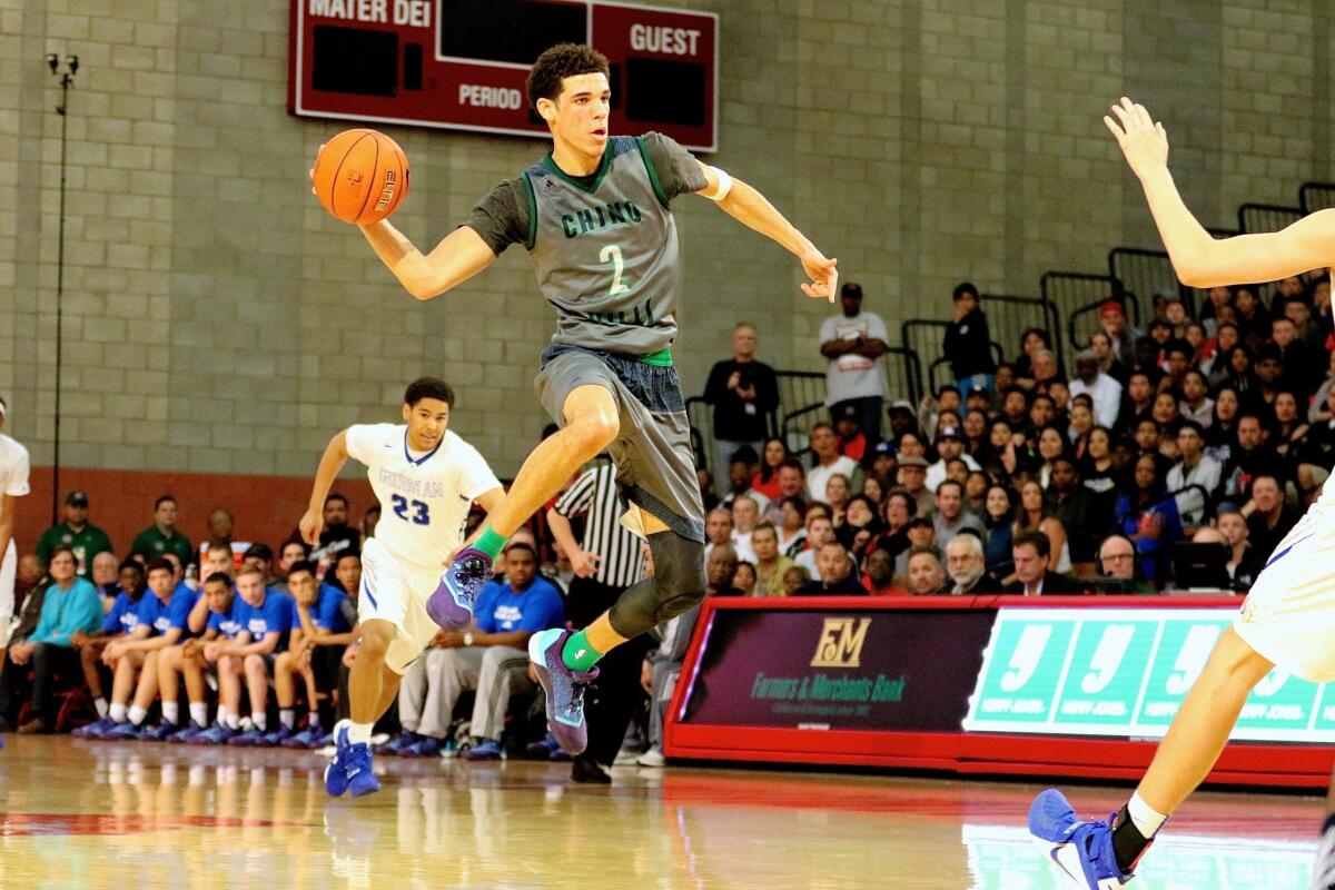 UCLA signee Lonzo Ball makes a leaping bounce pass from midcourt for one of his seven assists during Chino Hills' 98-81 victory over Bishop Gorman in the Nike Extravaganza at Mater Dei High.