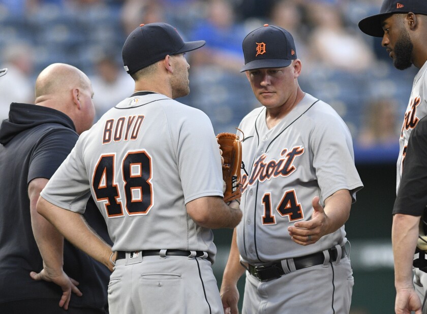 Detroit Tigers starting pitcher Matthew Boyd (48) comes out of a baseball game after talking to manager A.J. Hinch (14) during the third inning of a baseball game against the Kansas City Royals in Kansas City, Mo., Monday, June 14, 2021. (AP Photo/Reed Hoffmann)