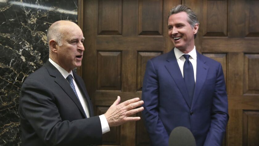 Gov.-elect Gavin Newsom, right, smiles as Gov. Jerry Brown responds to a reporter's question after meeting at the Capitol on Nov. 13, 2018, in Sacramento.