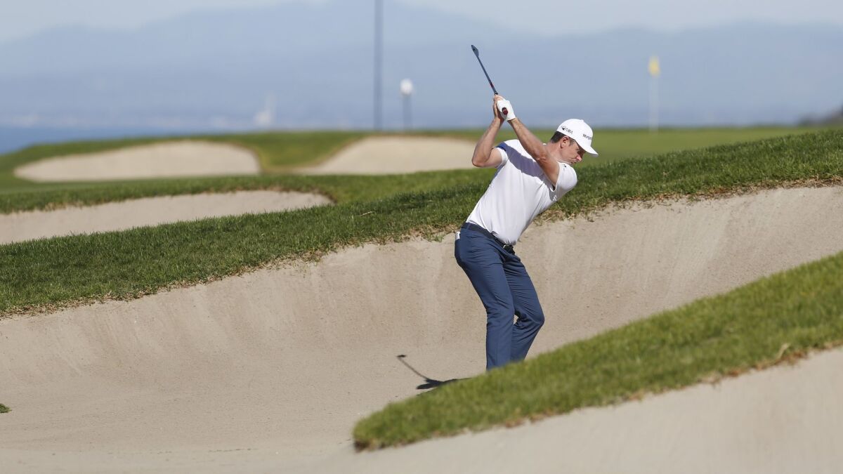 Justin Rose hits out of a bunker on the fourth hole during the third round of the Farmers Insurance Open. Rose's shot hooked into the canyon, leading to a double bogey.