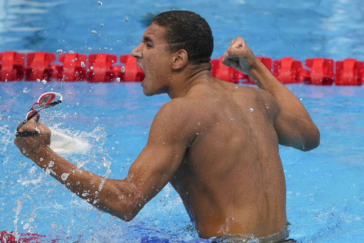 Ahmed Hafnaoui, of Tunisia, celebrates after winning the final of the men's 400-meter freestyle at the 2020 Summer Olympics, Sunday, July 25, 2021, in Tokyo, Japan. (AP Photo/Petr David Josek)