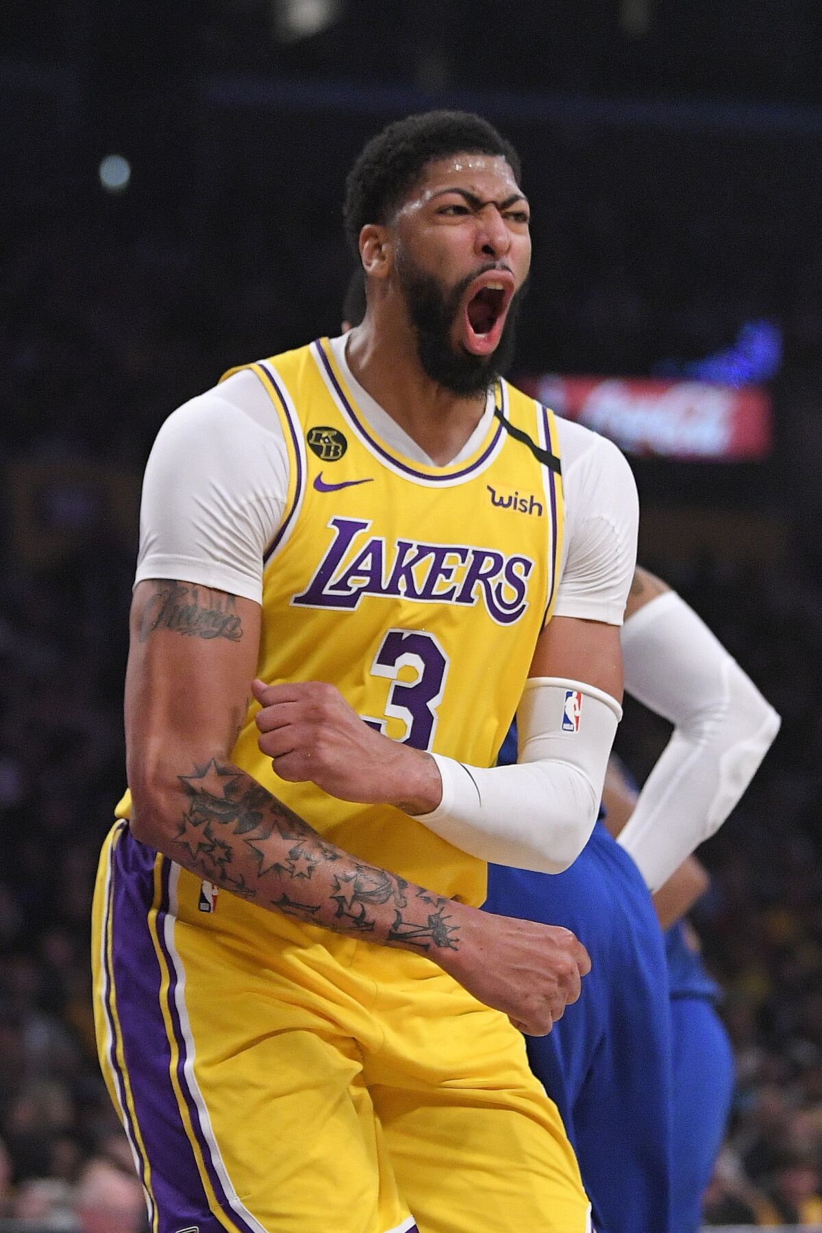 Los Angeles Lakers forward Anthony Davis celebrates after scoring during the first half of an NBA basketball game against the Philadelphia 76ers Tuesday, March 3, 2020, in Los Angeles. (AP Photo/Mark J. Terrill)
