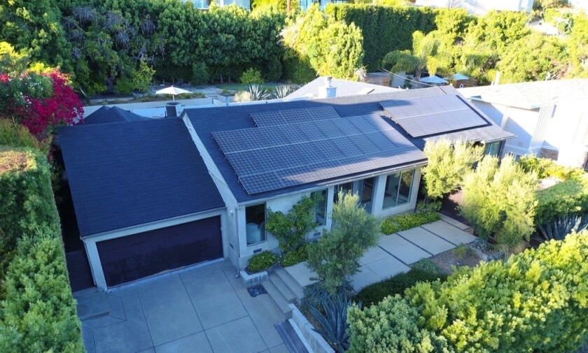 The property includes a three-bedroom home and a tiered backyard with a pool and putting green.
