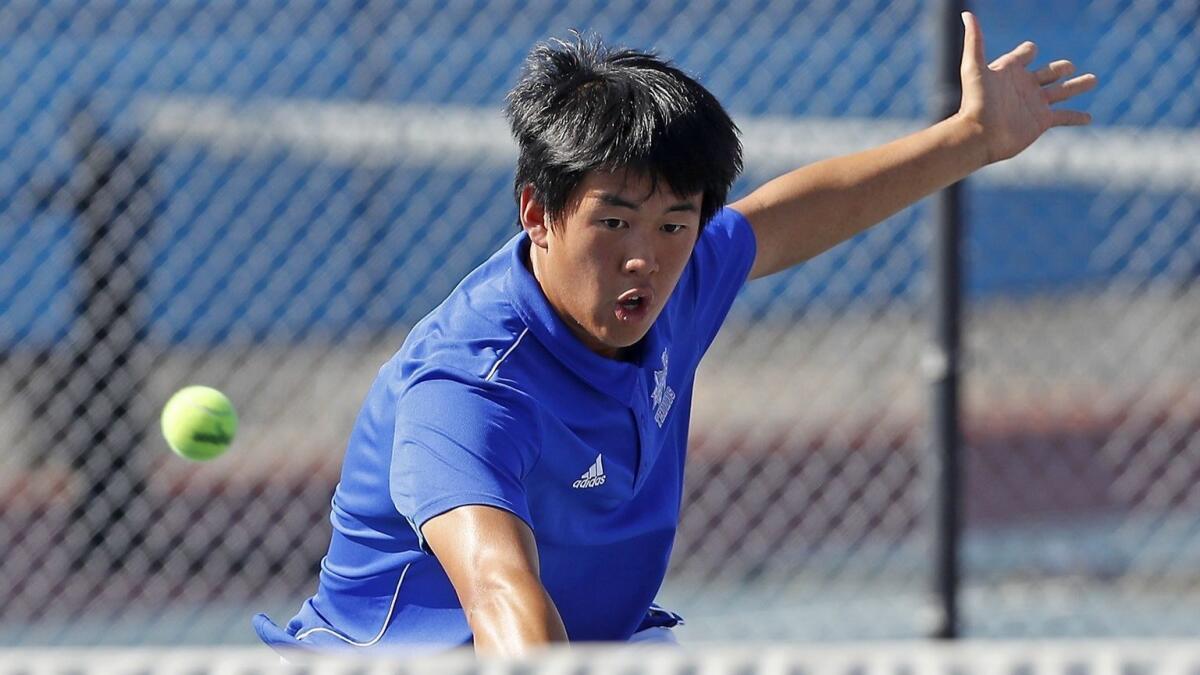 Fountain Valley High's Tommy Trinh competes during a No. 1 doubles set against Los Alamitos in a Sunset League match on April 17.