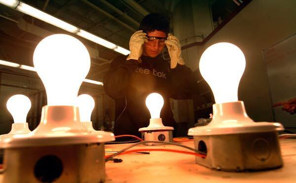 Student Manuel Contreres, 15, fits his protective glasses while working on an electrical project.
