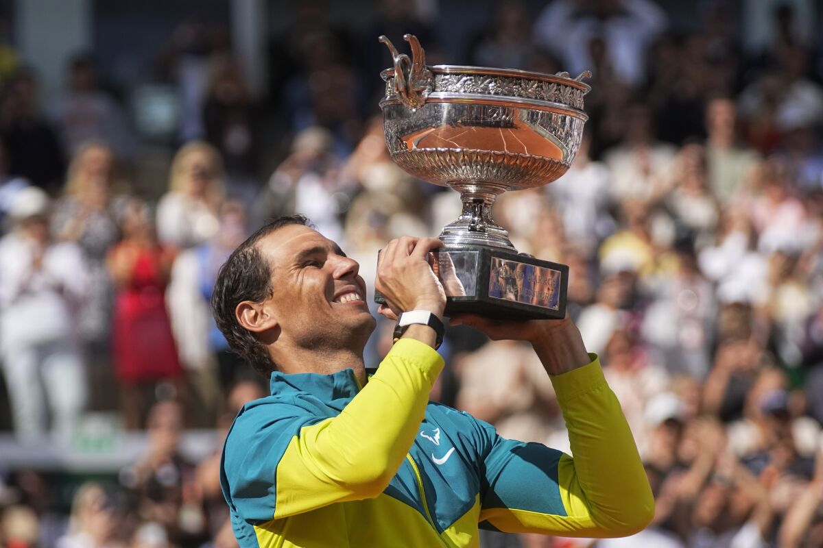 Spain's Rafael Nadal holds the trophy after winning the final match against Norway's Casper Ruud in three sets, 6-3, 6-3, 6-0, at the French Open tennis tournament in Roland Garros stadium in Paris, France, Sunday, June 5, 2022. (AP Photo/Michel Euler)