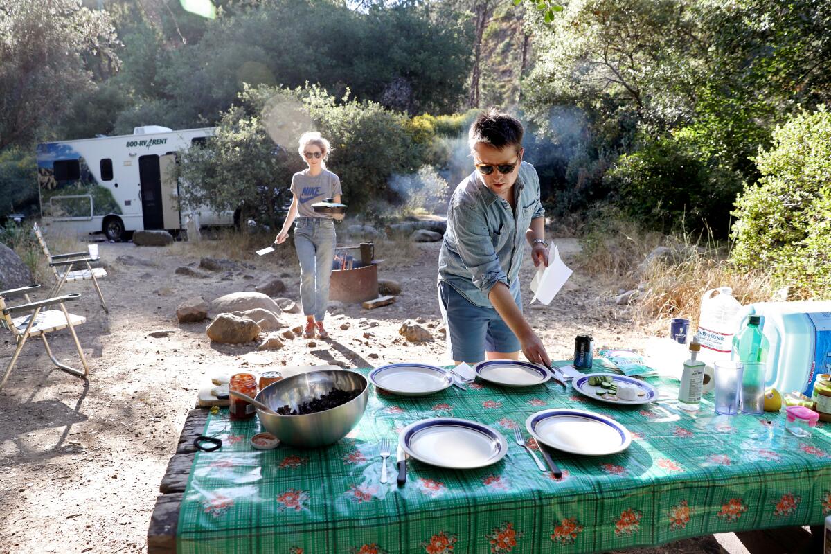 Times staff writer Daniel Miller and his wife, Jessica, prepare dinner while RV camping.