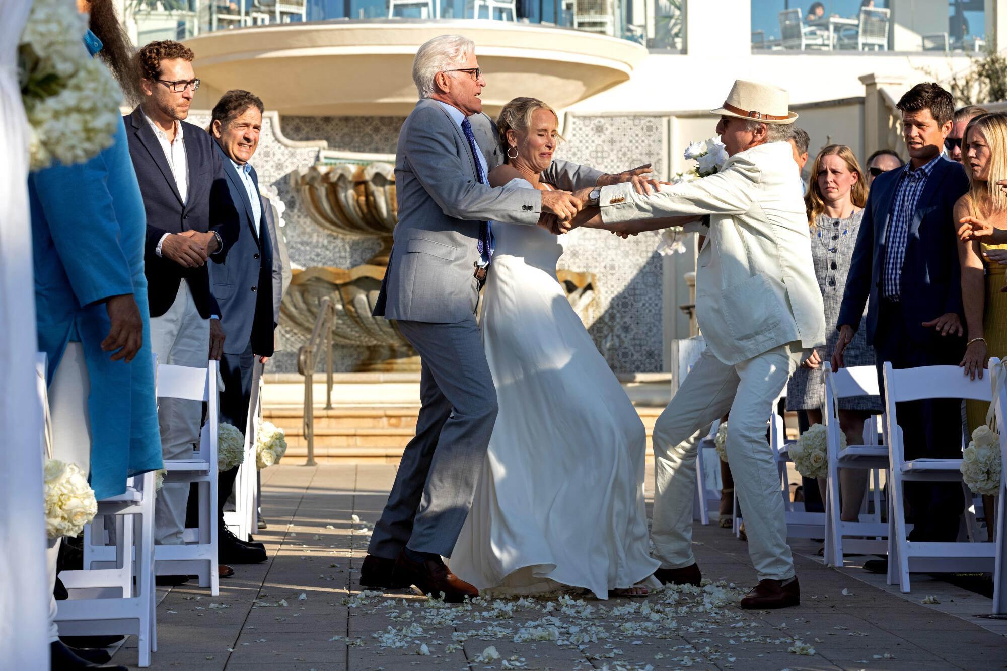 Two men fight with a bride caught between them