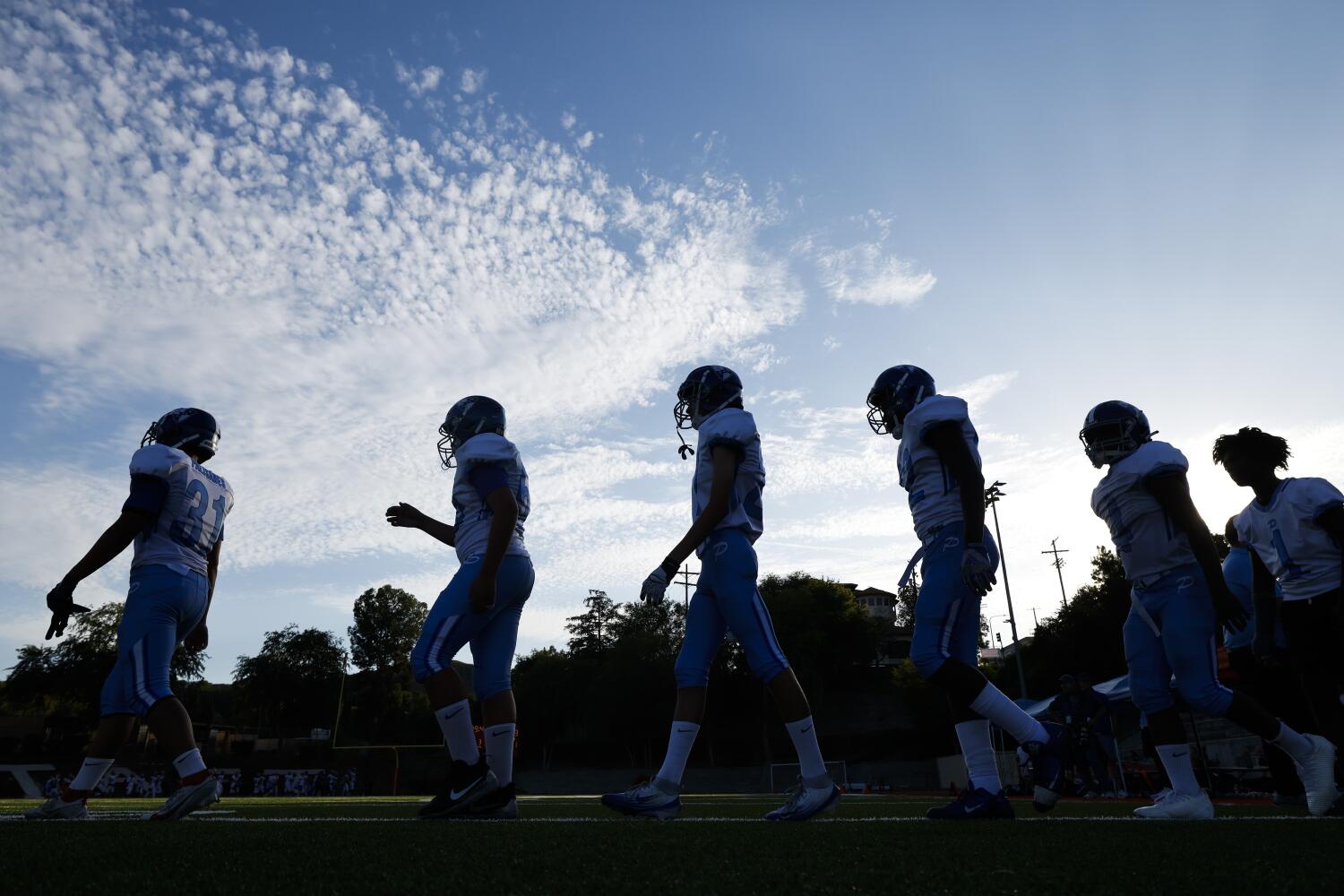 Los Angeles, CA - August 22: Pali High players line up to shake hands with Taft players after Pali's victory at the JV football game between Palisades High School and Taft High School on Friday, Aug. 22, 2025 in Woodland Hills, CA. (Carlin Stiehl / Los Angeles Times)