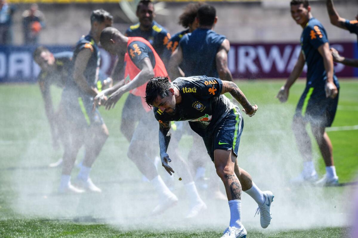 Brazil's national team players break an egg on the head of Fagner (C), who celebrated his birthday the day before, during a training session at Sochi Municipal Stadium in Sochi on June 12, 2018, ahead of the Russia 2018 World Cup football tournament.