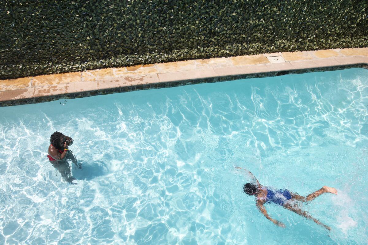 Overhead view of two people in a swimming pool  