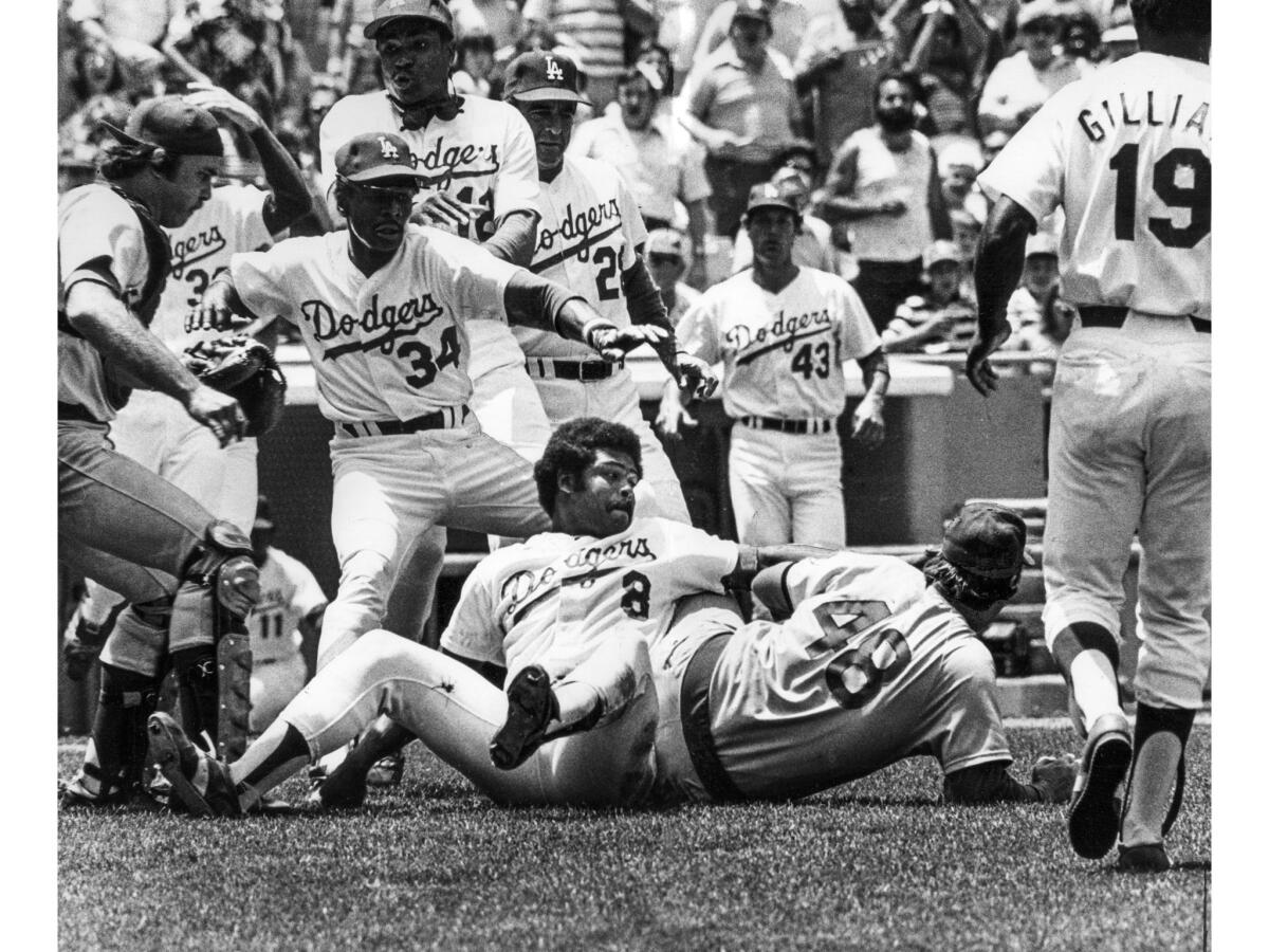 June 19, 1977: The Dodgers' Reggie Smith (#8), still trying to get Cubs pitcher Rick Reuschel after punching him.