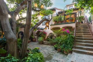 Built in 1927, the two-story home features Mediterranean style with rustic beams, stone floors, arched doorways and stained glass skylights.