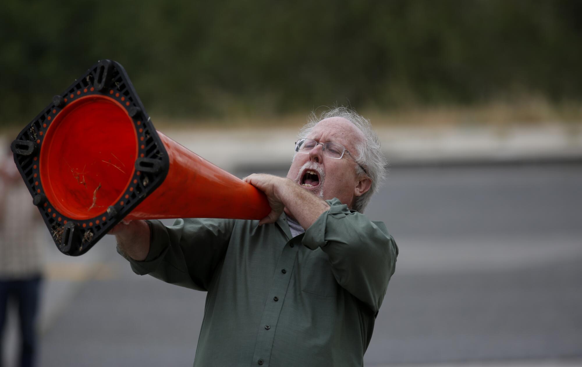A man chants along with dozens of protesters at the Aliso Canyon storage facility in 2016.