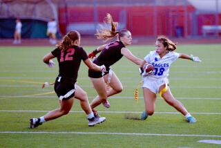 Santa Margarita's Mackenzie Young tries to evade two Orange Lutheran defenders during a Trinity League game.