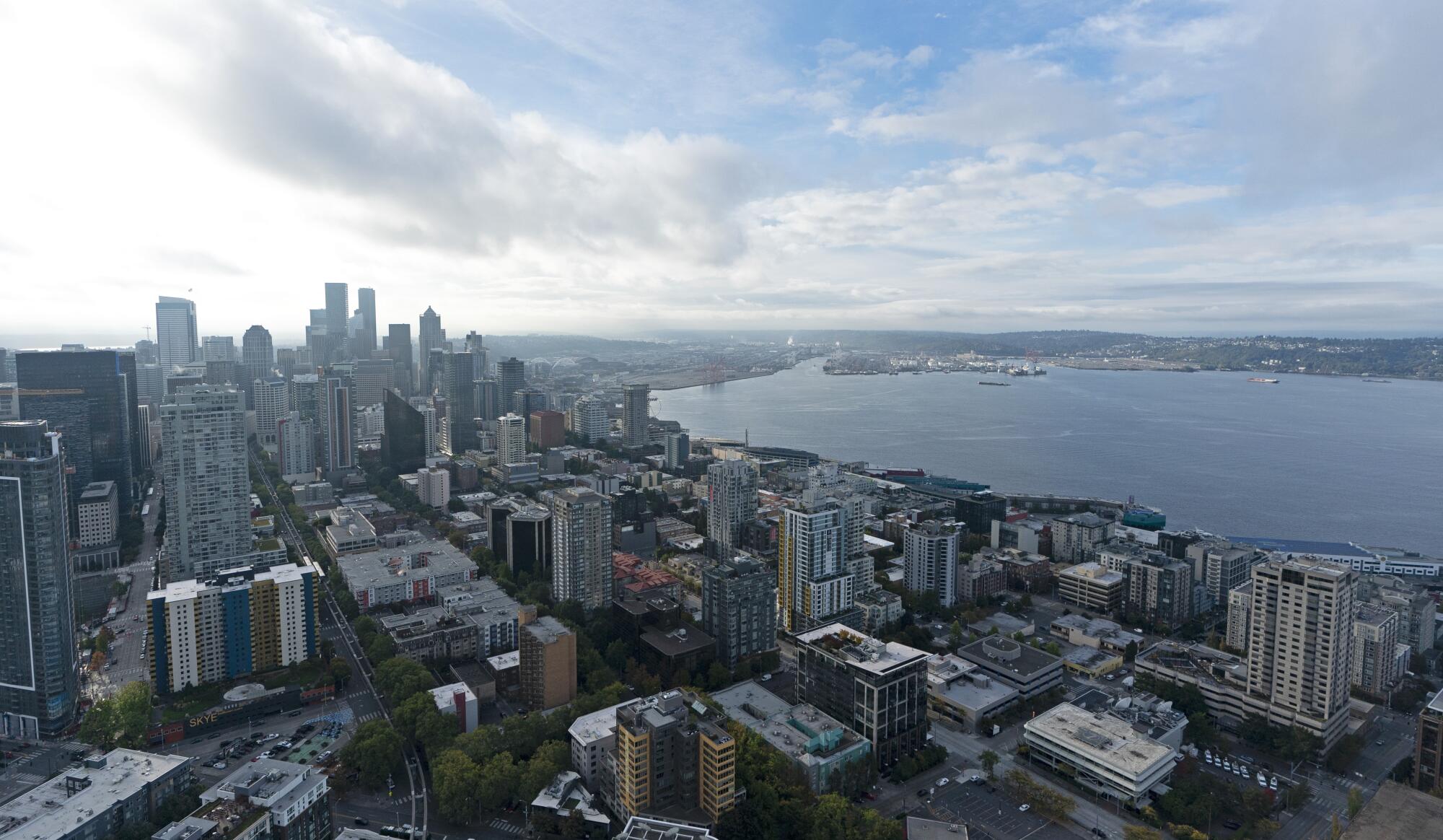 Blue skies begin to appear over downtown Seattle and Elliott Bay.