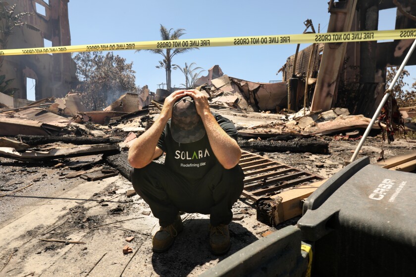 Laguna Niguel, California-May 12, 2022-Matthew Vogel, age 39, in front of his parents home, where he grew up in the Coronado Pointe neighborhood. The home was completely destroyed last night. At least 20 homes in Laguna Niguel were destroyed by fire, fueled by winds and dry conditions caused by California's intense drought on May 12, 2022. (Carolyn Cole / Los Angeles Times)