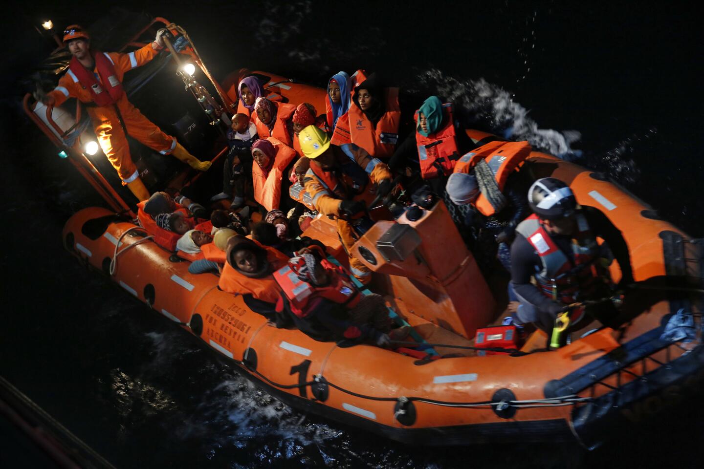 Migrants from a wooden boat are transported by the rescue team of Save the Children to the Vos Hestia off the coast of northern Libya.