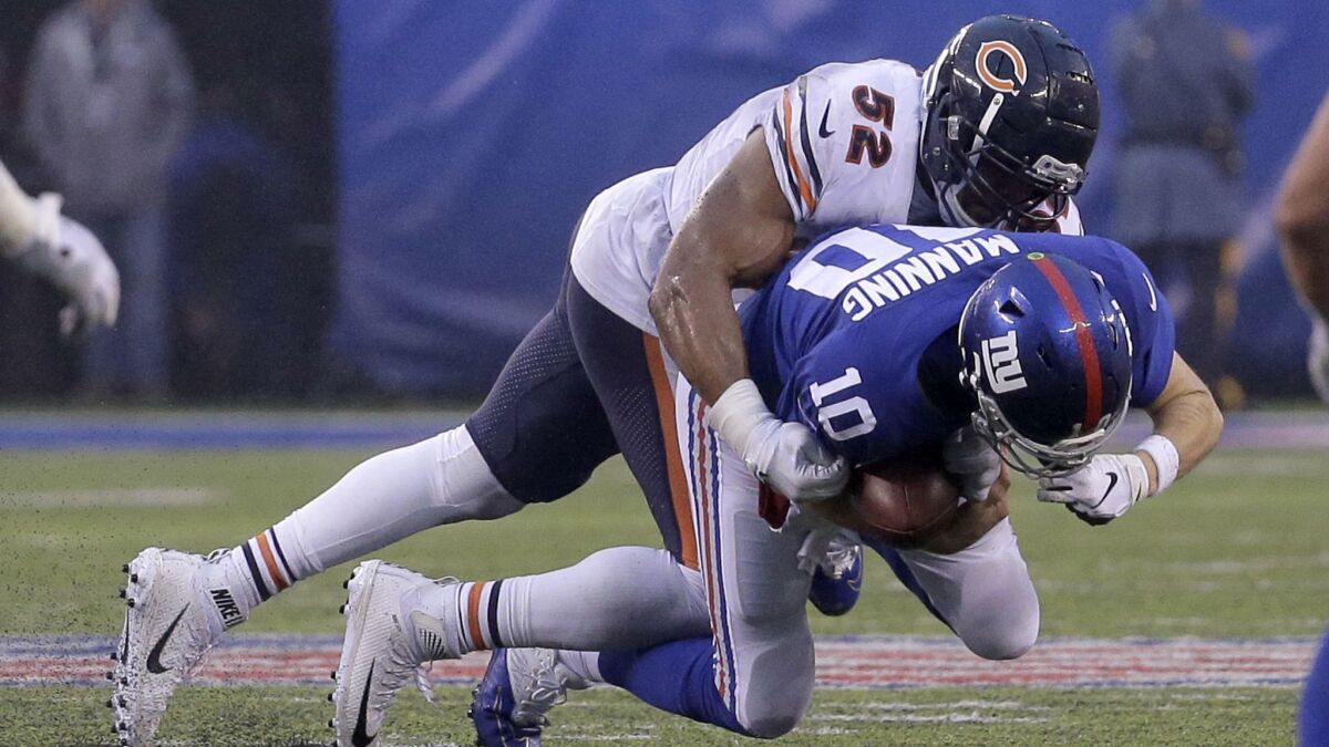 New York Giants quarterback Eli Manning (10) is sacked by Chicago Bears outside linebacker Khalil Mack (52).