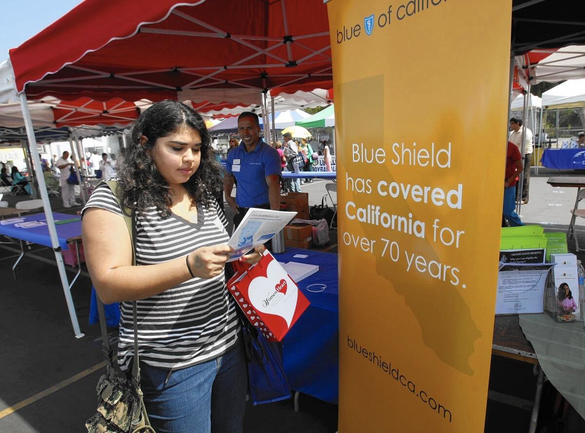 Blue Shield of California led the country with $107 million in profit on Obamacare policies sold to individuals. Kaiser Permanente was second with $66 million, and Anthem Blue Cross ranked seventh nationally with a $9-million surplus in the Covered California exchange. Above, Sophia Bracho gets information from Blue Shield of California in 2013.