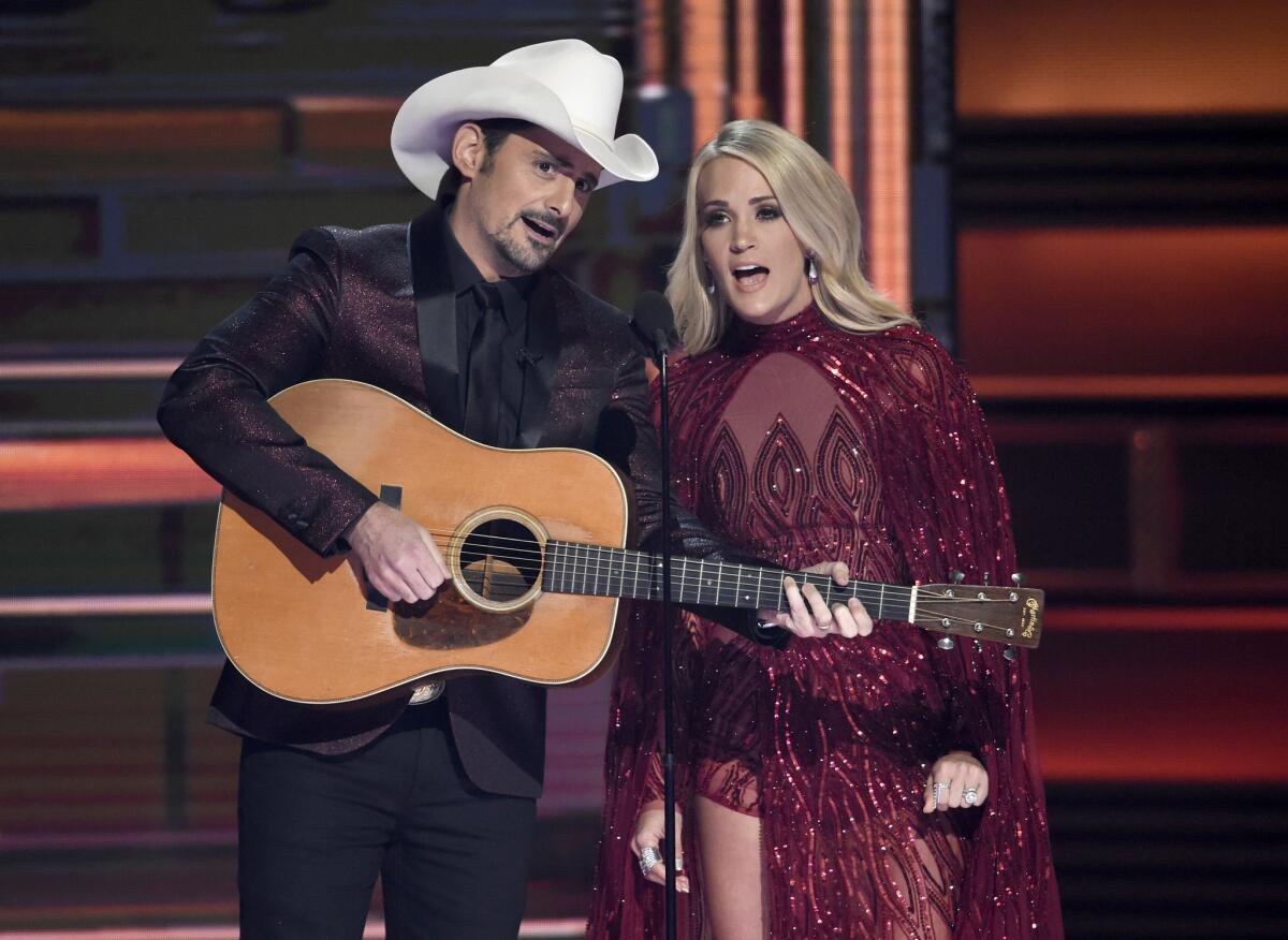 Co-hosts Brad Paisley and Carrie Underwood perform Wednesday night at the 51st CMA Awards in Nashville.