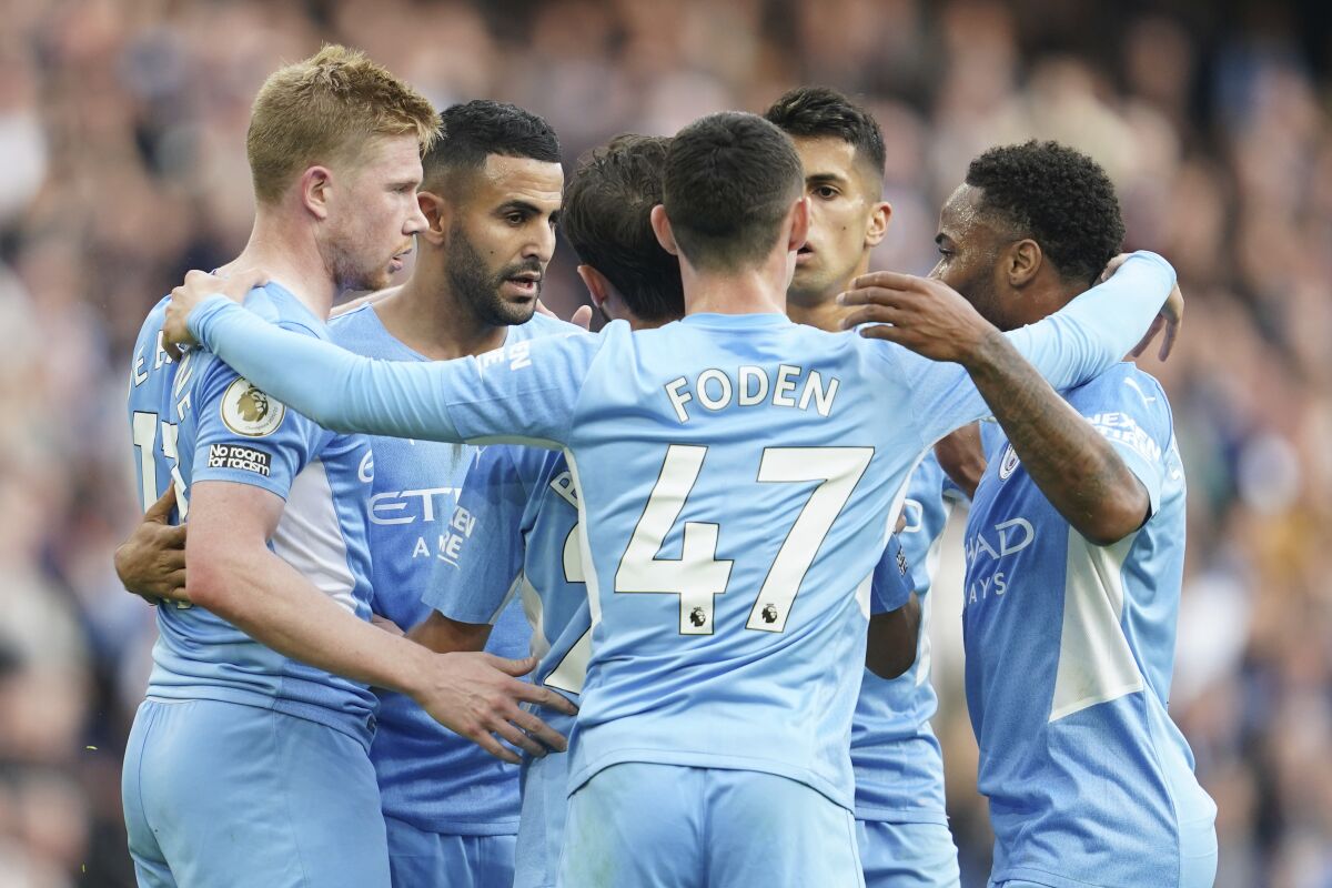 Manchester City's Kevin De Bruyne, left, celebrates with his teammates after scoring his side's second goal during the English Premier League soccer match between Manchester City and Burnley at Etihad stadium in Manchester, England, Saturday, Oct. 16, 2021. (AP Photo/Jon Super)