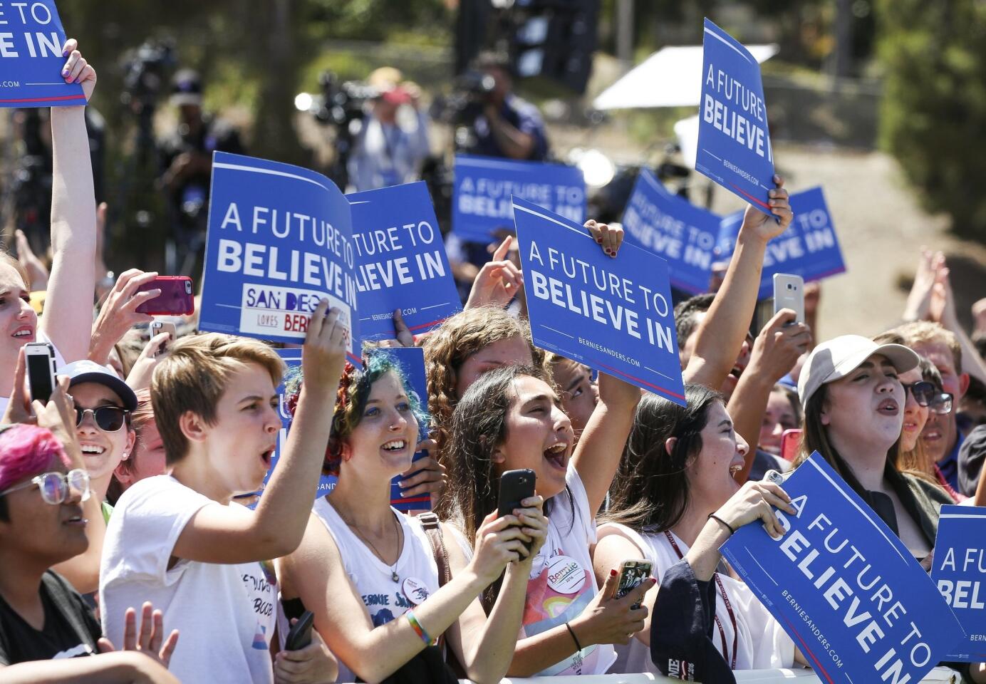 Bernie Sanders supporters cheer after Democratic presidential candidate Bernie Sanders arrives at Rancho Buena Vista High School.