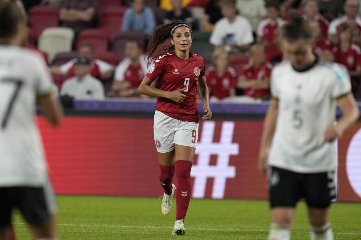 Nadia Nadim runs on the field for Denmark during a match against Germany during Women's Euro 2022 in July.