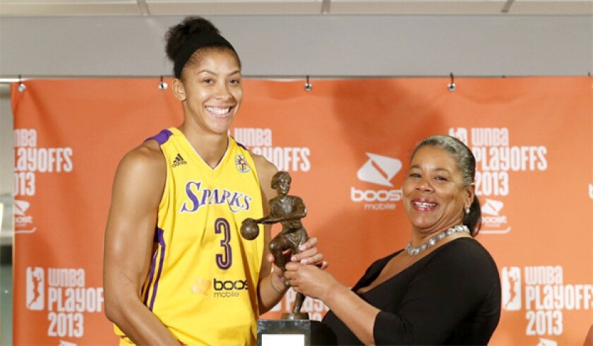 WNBA President Laurel J. Richie, right, presents the Sparks' Candace Parker, left, with the WNBA Most Valuable Player award