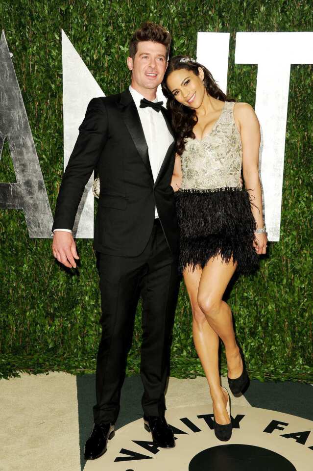 Singer Robin Thicke, left, and his wife, "Mission: Impossible - Ghost Protocol" actress Paula Patton.