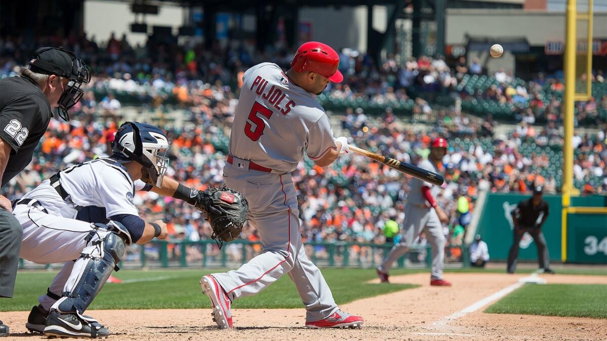 Albert Pujols hits a sacrifice fly in the fifth inning of the Angels' 11-4 win over the Detroit Tigers.