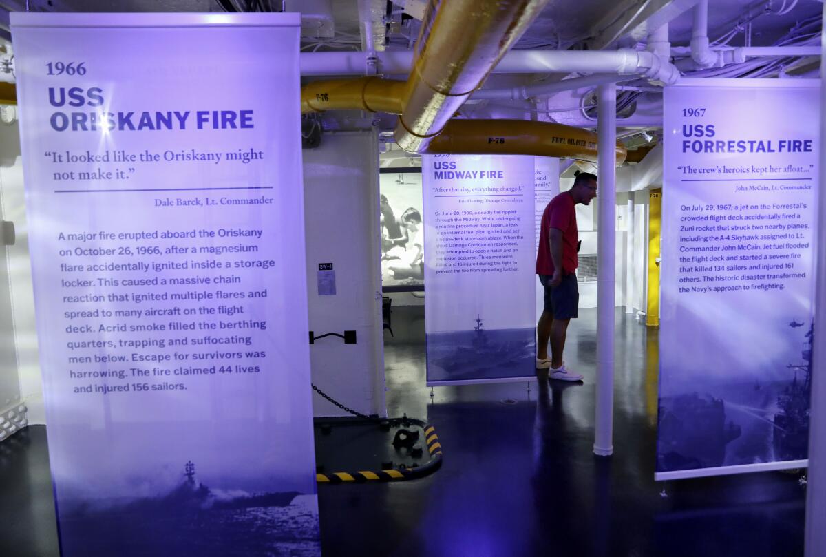 Guests walk through the USS Midway's new exhibit "Midway's Engineers: Service, Sacrifice and Everyday Life". 