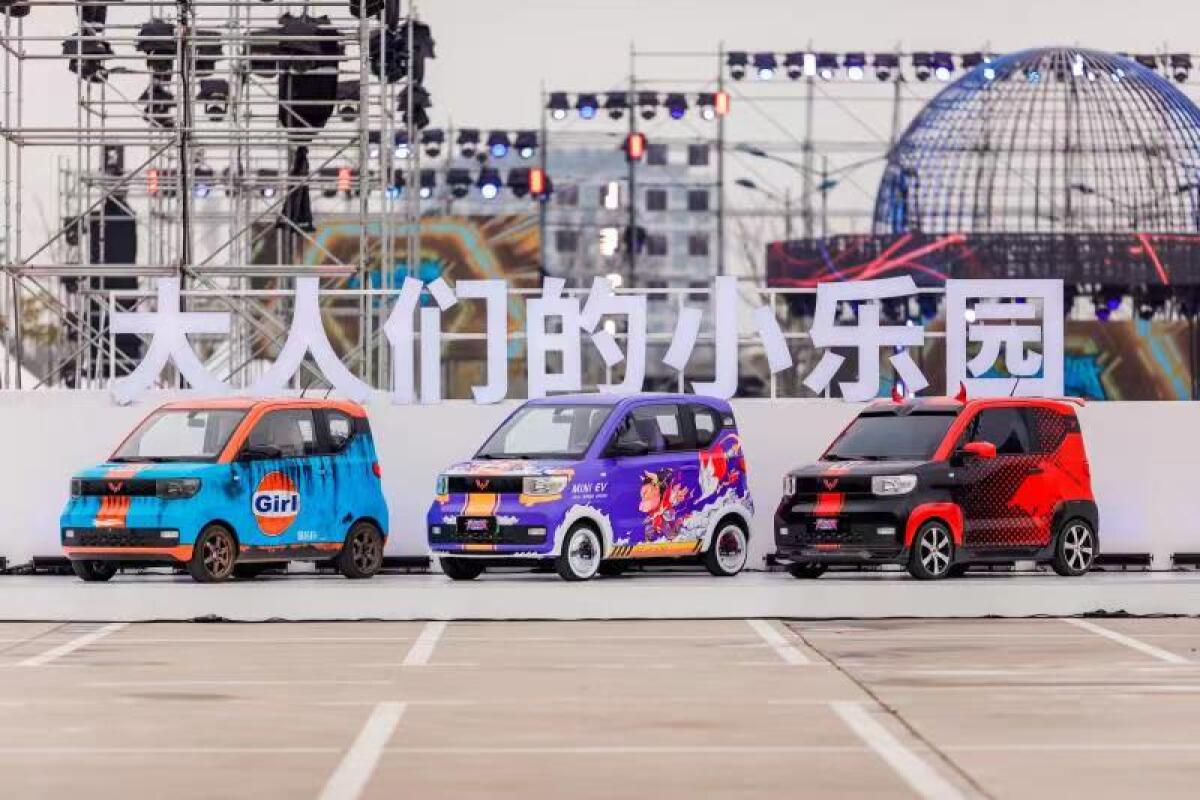 Three brightly colored Chinese electric vehicles.