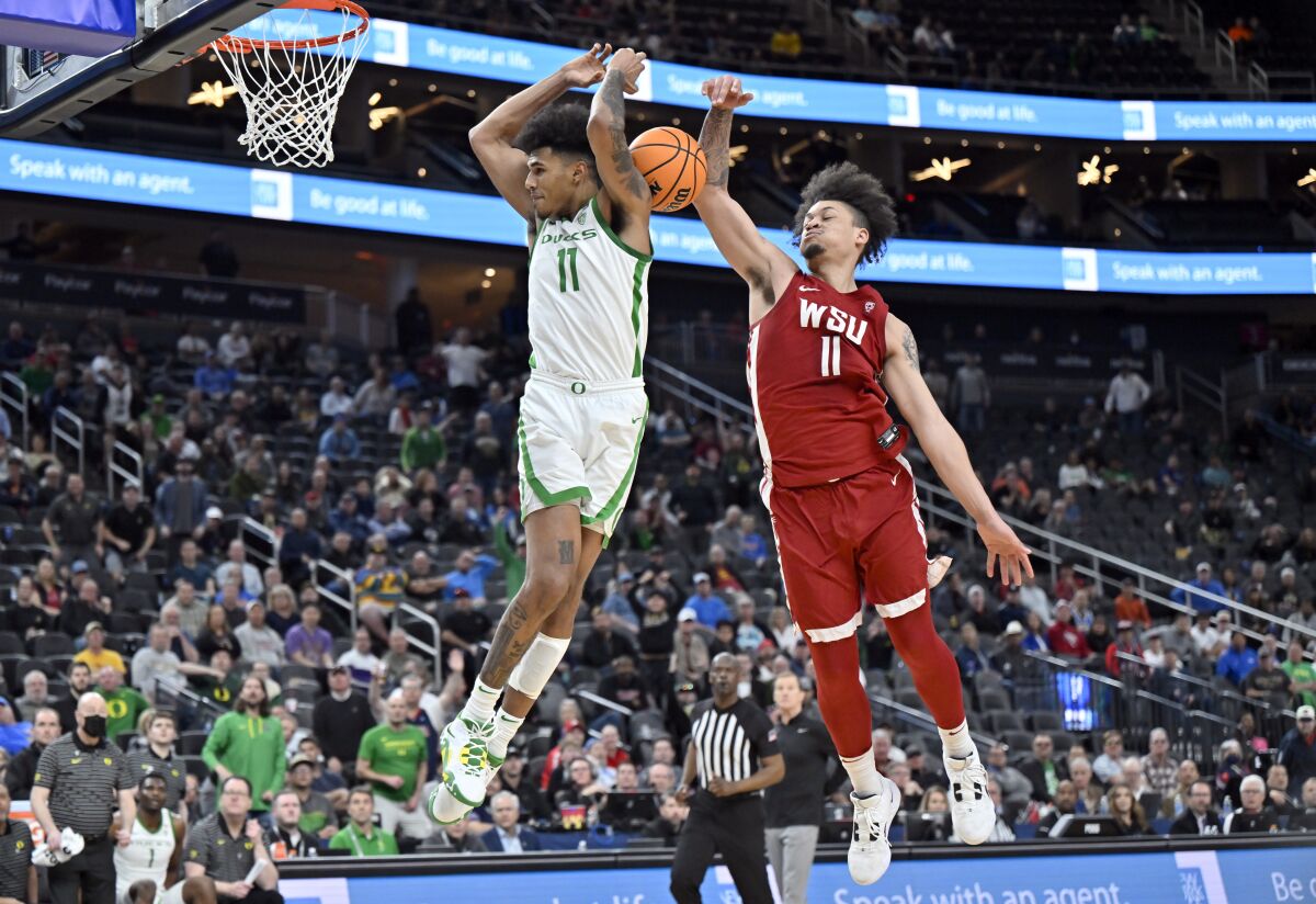 Oregon guard Rivaldo Soares shoots against Washington State forward DJ Rodman.