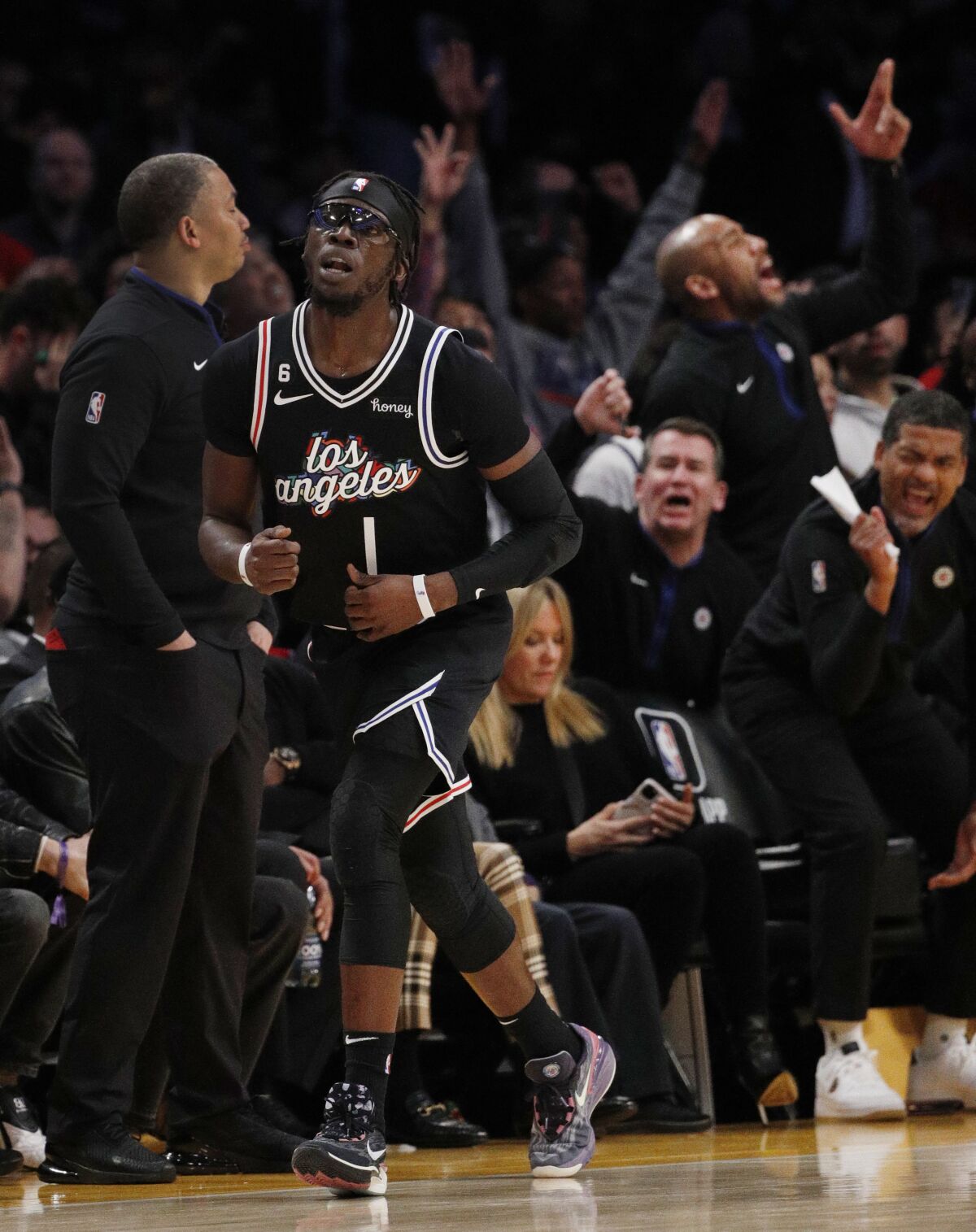 The Clippers bench reacts after guard Reggie Jackson (1) sinks a three-point shot.