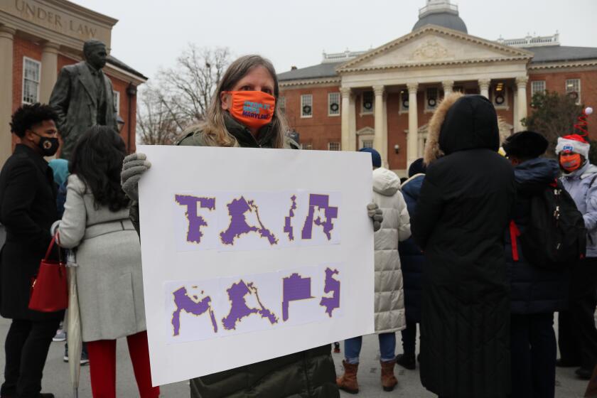 Amanda SubbaRao holds a sign calling for “Fair Maps” during a rally in Annapolis, Md., on Wednesday, Dec. 8, 2021. She was attending a rally opposing gerrymandering, in which politicians draw districts to benefit their party. The Maryland General Assembly is in a special session to approve a new congressional map for the state’s eight U.S. House seats after the recent census. (AP Photo/Brian Witte)