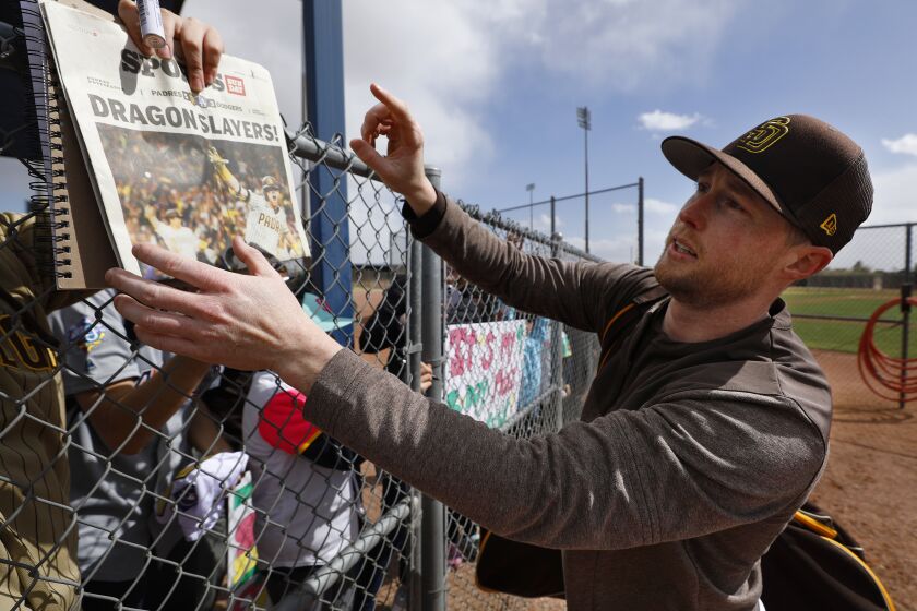 Peoria AZ - February 22: San Diego Padres' Jake Cronenworth signs an autograph after a spring training practice on Wednesday, February 22, 2023 in Peoria, AZ. (K.C. Alfred / The San Diego Union-Tribune)