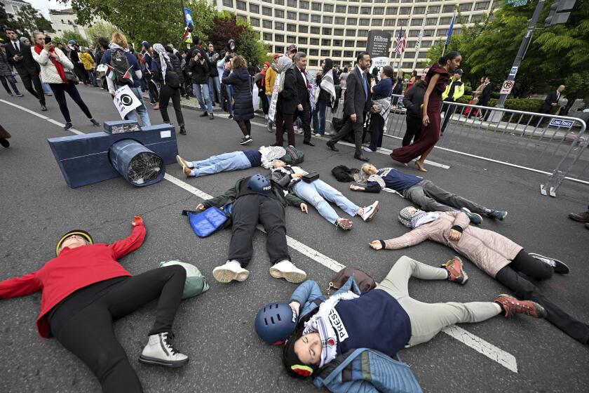 Demonstrators lay in the street during a pro-Palestinian protest over the Israel-Hamas war before the White House Correspondents' Association Dinner at the Washington Hilton, Saturday April 27, 2024, in Washington. (AP Photo/Terrance Williams)