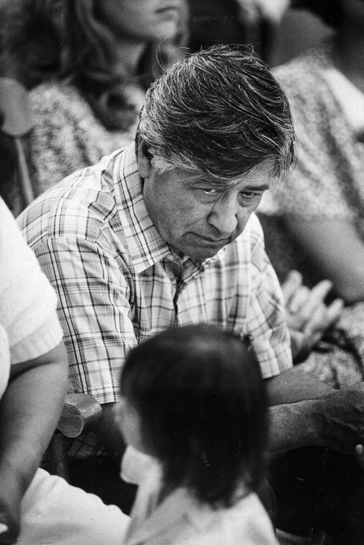 Aug. 4, 1988: Cesar Chavez gestures to one of his granddaughters to behave during a Mass in Delano, on his 18th day of fasting against the use of certain pesticides on grape crops.