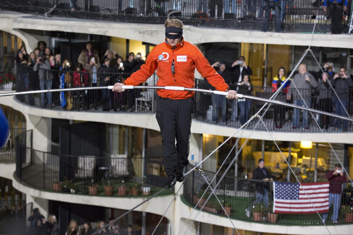 Nik Wallenda walks across the Chicago skyline blindfolded for Discovery Channel's "Skyscraper Live With Nik Wallenda" on Sunday.