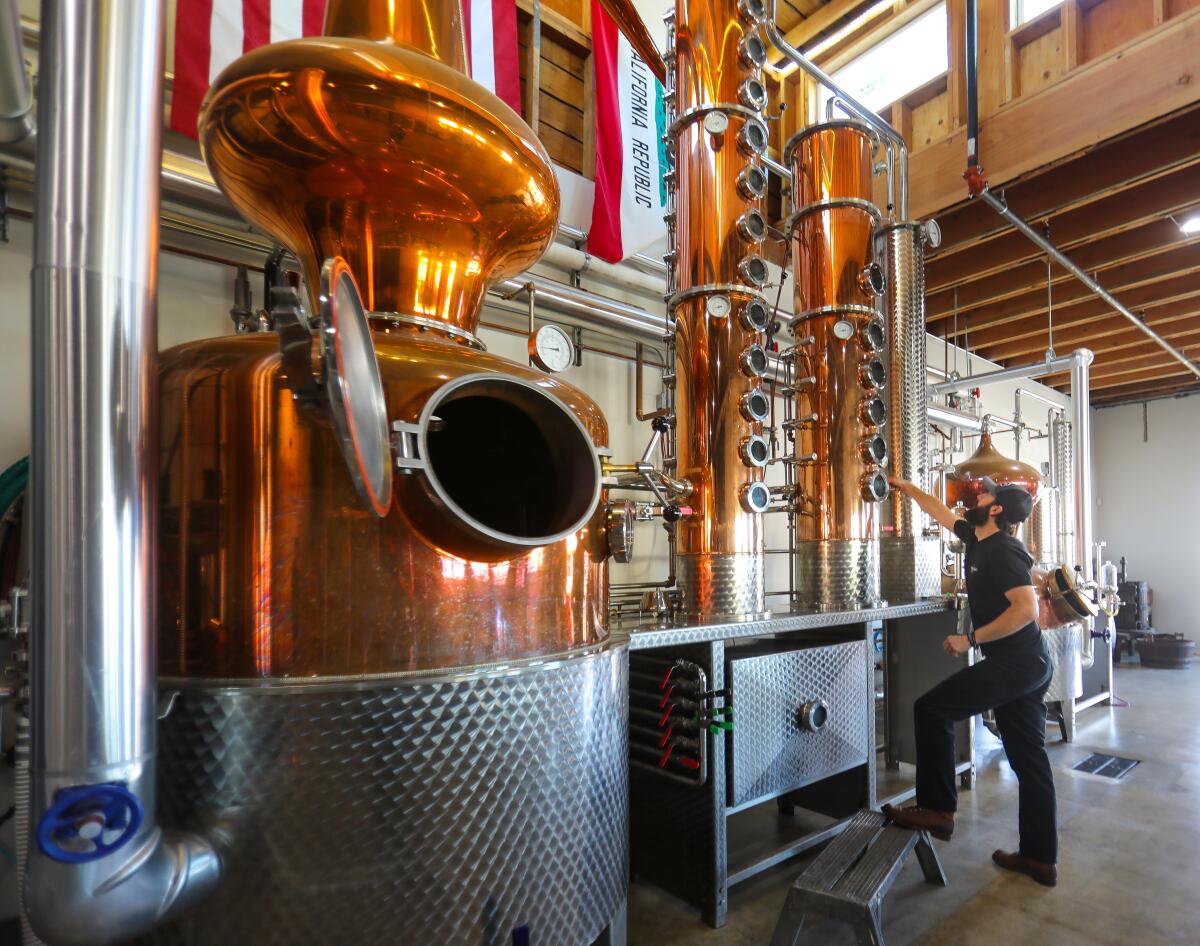 Nicholas Hammond, founder and head distiller at Pacific Coast Spirits prepares the German built still that will make red corn whiskey, January 29, 2020 in Oceanside, California.
